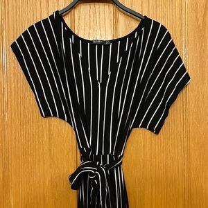 Black and white short sleeve jumpsuit. Wide legged. Front tie